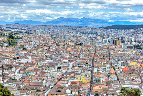 High view of Quito, from the Panecillo hill, on a cloudy and overcast afternoon. Quito, Ecuador.
