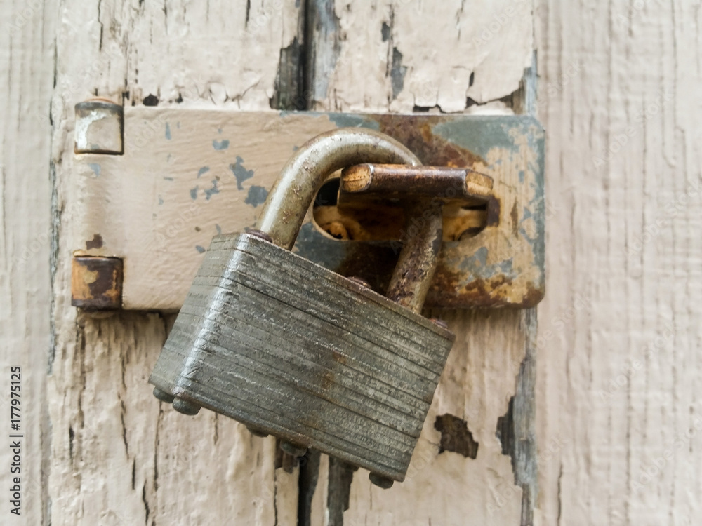 Padlock On A Latch With Rust And Chipping Paint Padlock On A Latch With Rust And Chipping Paint