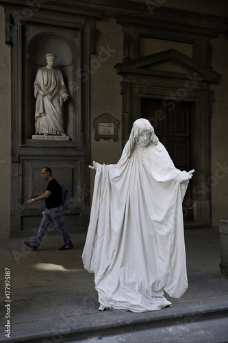 Florence, Tuscany - April 09, 2011, Statue of Cosimo Pater Patriae  with a street artist
