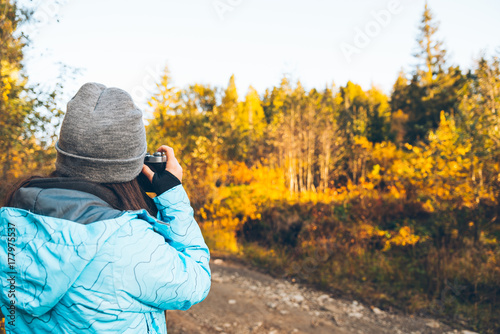 woman taking picture of the autumn carpathian mointains