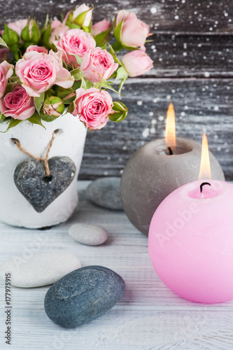 Heart, pink roses in concrete pot with candles