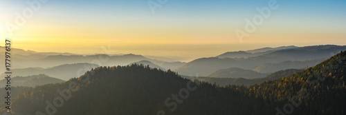Autumn landscape - Black Forest. Panoramic view over the autumnal Black Forest, the Rhine valley and the Vosges (France) in the distance at sunset. photo