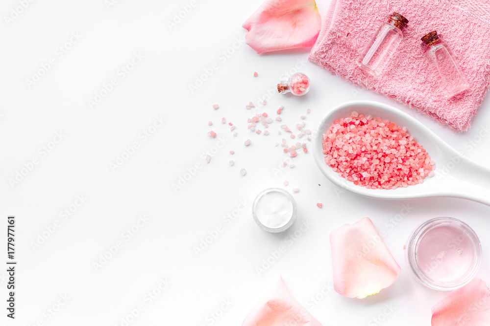 Spa products with rose oil. Cream, lotion and salt on white background top view copyspace Spa products with rose oil. Cream, lotion and salt on white background top view copyspace