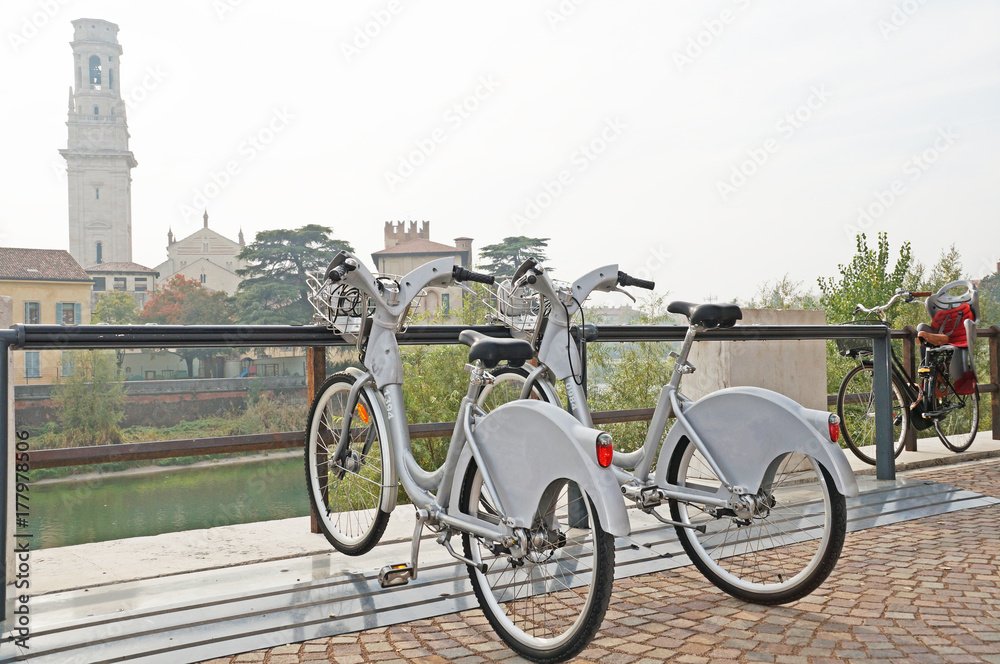 Fototapeta premium Two bicycles are parked in a beautiful city. Bicycles on the background of the cityscape.