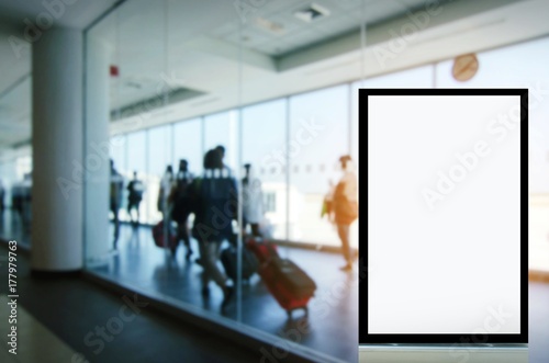 mock up of blank showcase billboard or advertising light box for your text message or media content with people and traveling luggage walking in airport, commercial, marketing and advertising concept © Vittaya_25