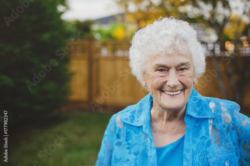 Happy portrait of old - elderly - woman in backyard photo