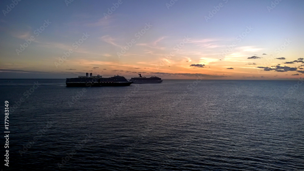 Two luxury cruise liners heading into sunset
