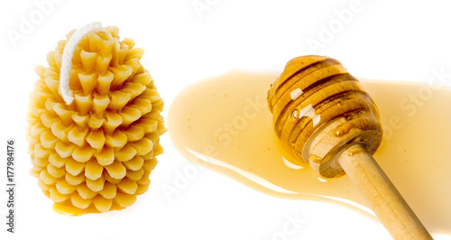 Bees products - honey and Candle made of beeswax isolated on a white background