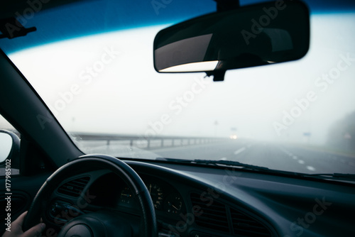 man driving car in fog