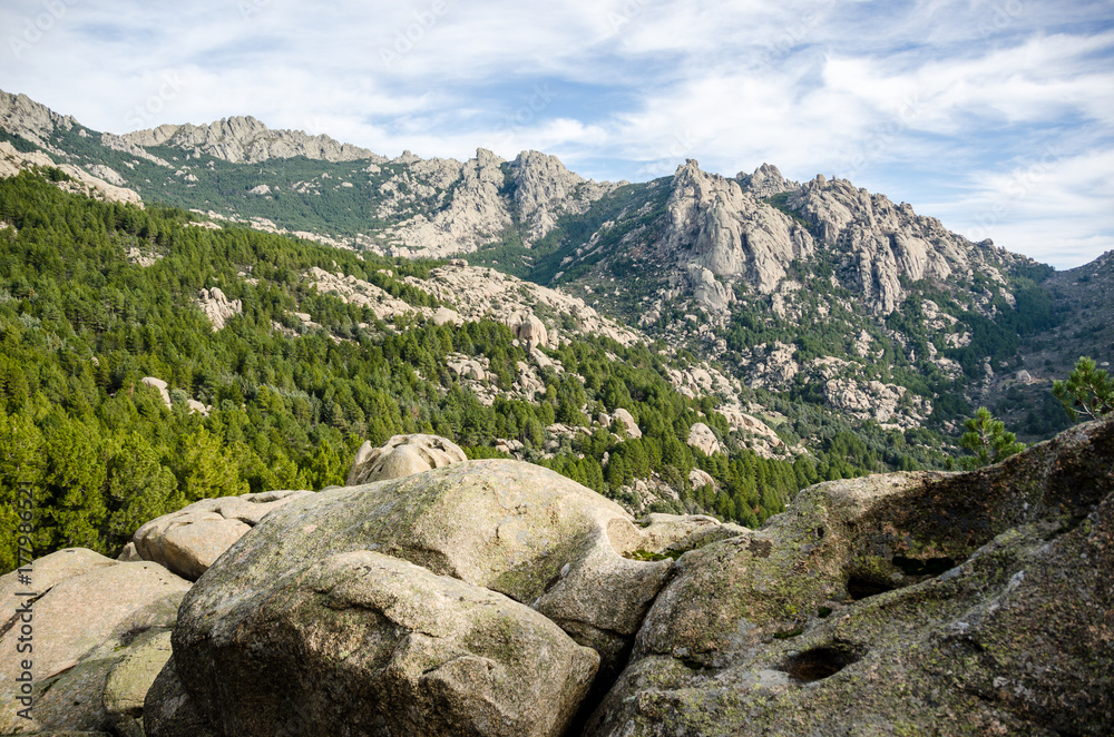 Stones, trees and mountains of La Pedriza Regional Park in Madrid (Spain)