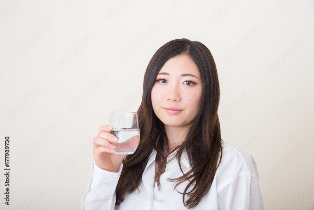 young asian woman with glass of water young asian woman with glass of water