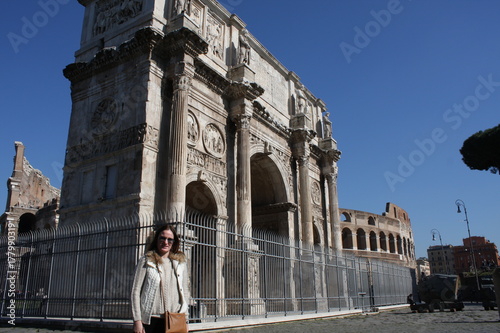 tourist next to the Triumphal Arch of Constantine, dedicated in AD 315 to celebrate Constantine'