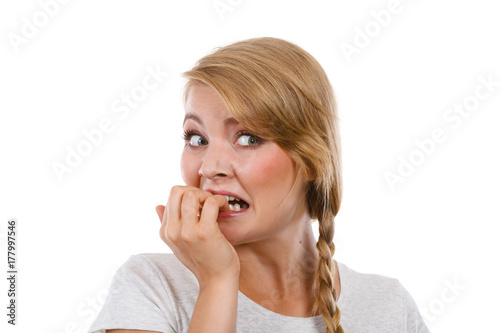 Scared, stressed woman biting her nails