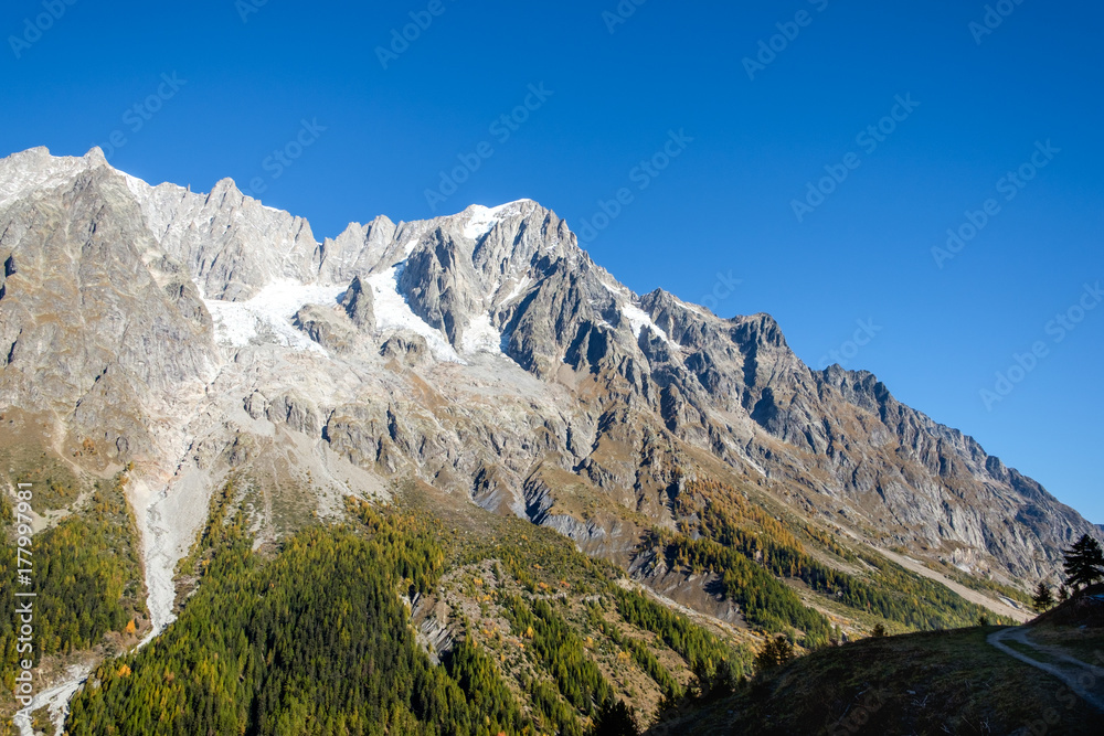 View of mountain peaks, valleys and pine tree forests in Val Ferret, Aosta Valley, Italy View of mountain peaks, valleys and pine tree forests in Val Ferret, Aosta Valley, Italy