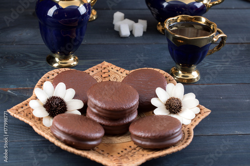 coffee on the table with background with cakes and apples