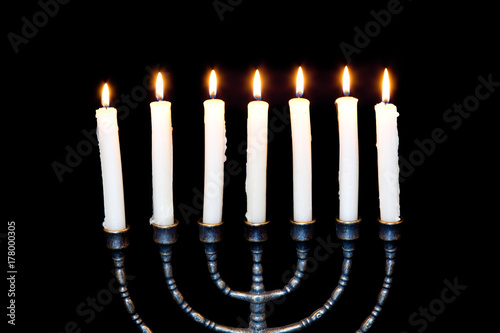 Ancient ritual candle menorah on a black background