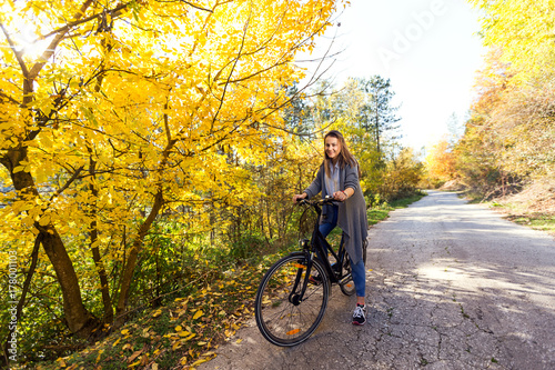 Young active sport girl with bicycle outdoor