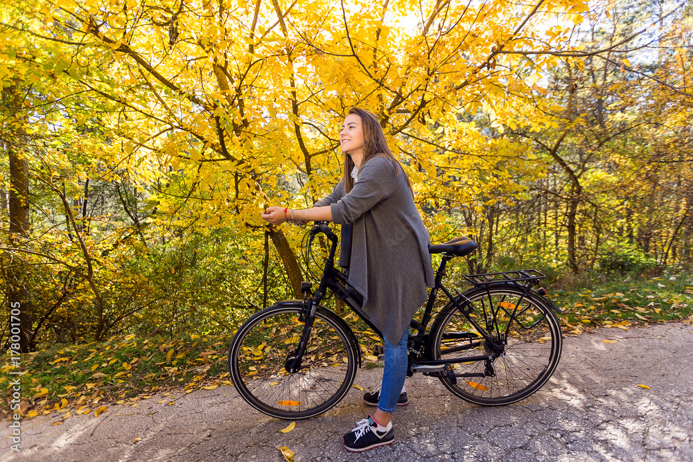 Young active sport girl with bicycle outdoor