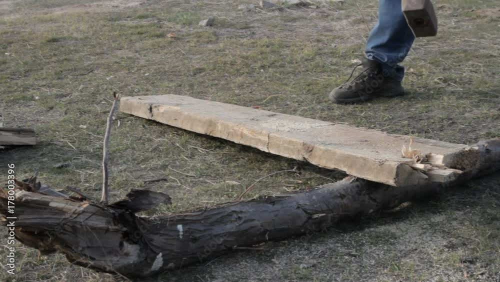man chops firewood using sledgehammers man chops firewood using sledgehammers