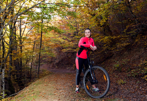 Young active sport girl with bicycle outdoor