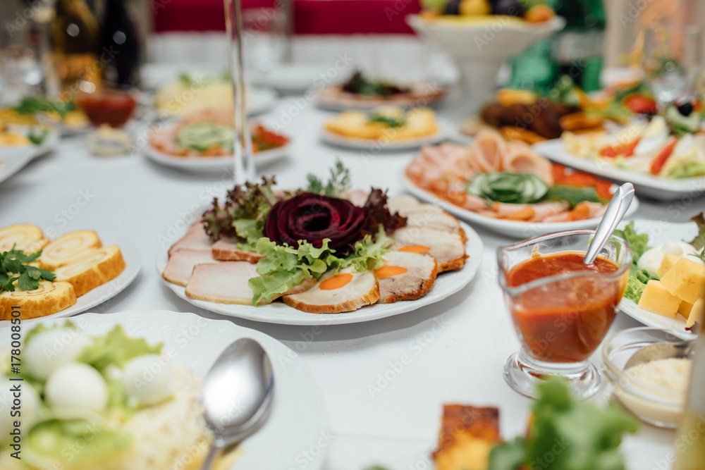 Tasty meat and vegetable snacks on the wedding table