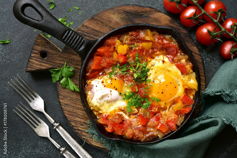 Shakshuka - eggs in tomato sauce.Top view. Shakshuka - eggs in tomato sauce.Top view.