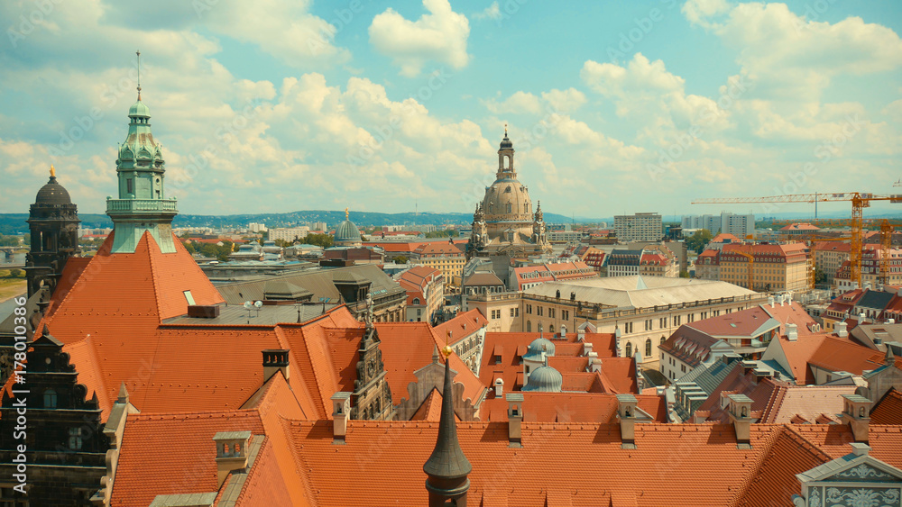 Old town of Dresden - baroque buildings red roofs of houses on the background of the river Elba create a beautiful landscape of the historic city.