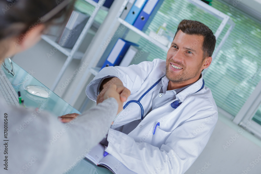 doctor shakes hands with a patient doctor shakes hands with a patient