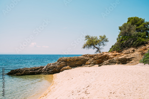 Beautiful sandy beach with clear blue water photo