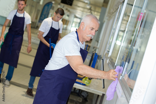 senior man cleaning window