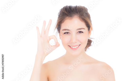 Portrait of beautiful asian woman makeup of cosmetic - girl hand gesture ok on attractive face with skin healthcare concept isolated on white background.