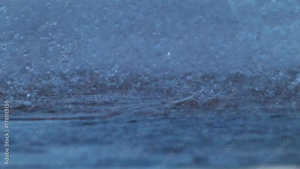 Water Drops on Asphalt Strong water flows, splashes and droplets flying in different directions Water Drops on Asphalt Strong water flows, splashes and droplets flying in different directions