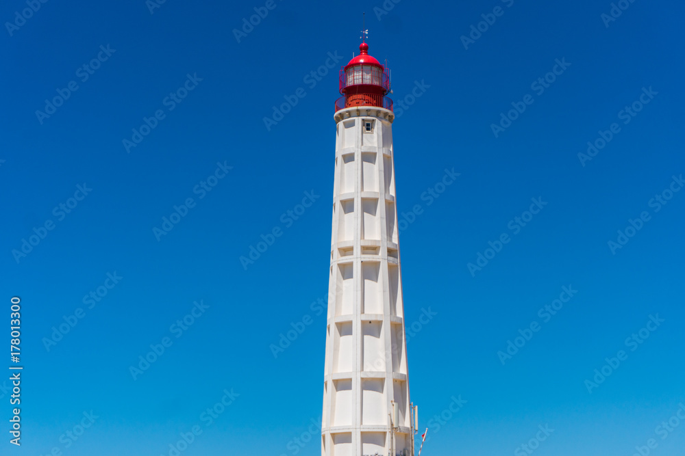 Lighthouse on the sea under blue sky on summer time
