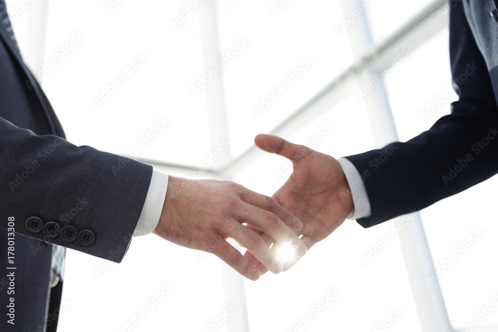 Two  business men going to make handshake