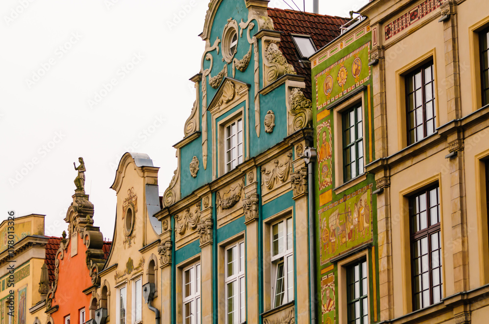 Fototapeta premium Buildings with ornate mural paintings on their fascades, and gable walls in Dluga, Dlugi Targ, Gdansk