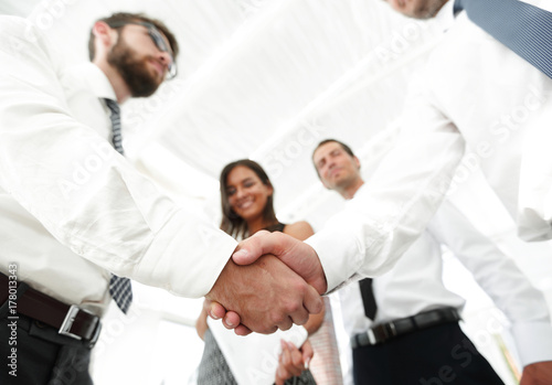 background image of handshake of business partners.