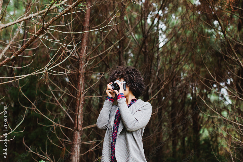 Woman taking a photo in a forest Woman taking a photo in a forest