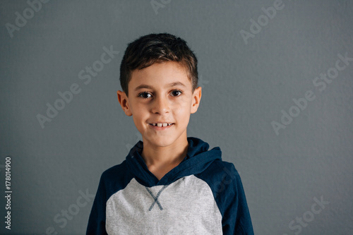 Portrait of Brazilian boy on gray background photo