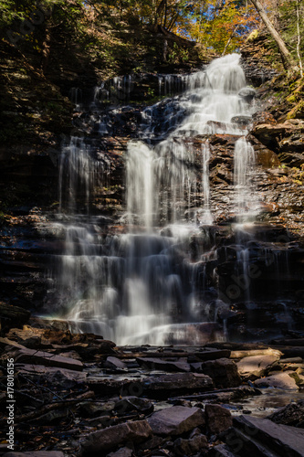 Waterfalls are surrounded by colorful fall foliage at Ricketts Glen State Park in Benton, PA
