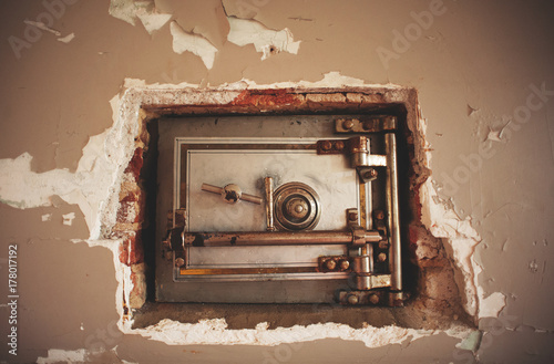An old safe hidden in the wall in an old prison photo