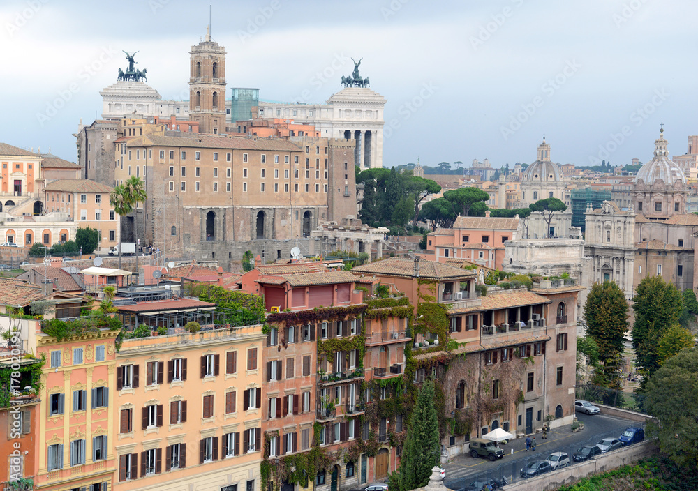 Cityscape with elevated view of city and commercial and residential buildings with tile rooftops in Rome, Italy