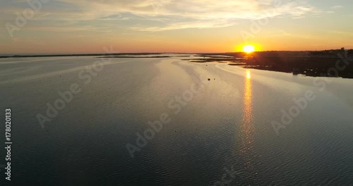 Aerial sunset and historic life-guard building at Fuseta fishing town, in Ria Formosa wetlands nature conservation park, Algarve. Portugal