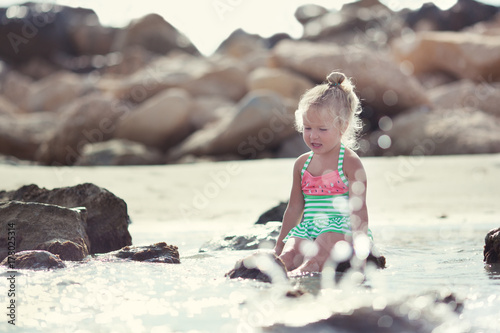 Little cute happy girl bathes in sea, © rimmdream