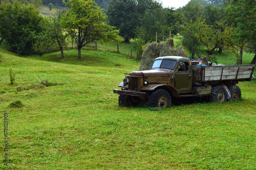 Very old gray truck without trademark on the green grass