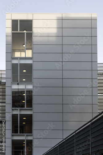 View from the outside of several floors of lifts in a commercial building