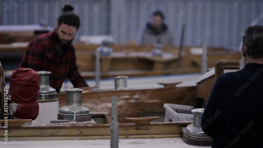  Workers in a boatyard, working on construction & renovation of sailing boats