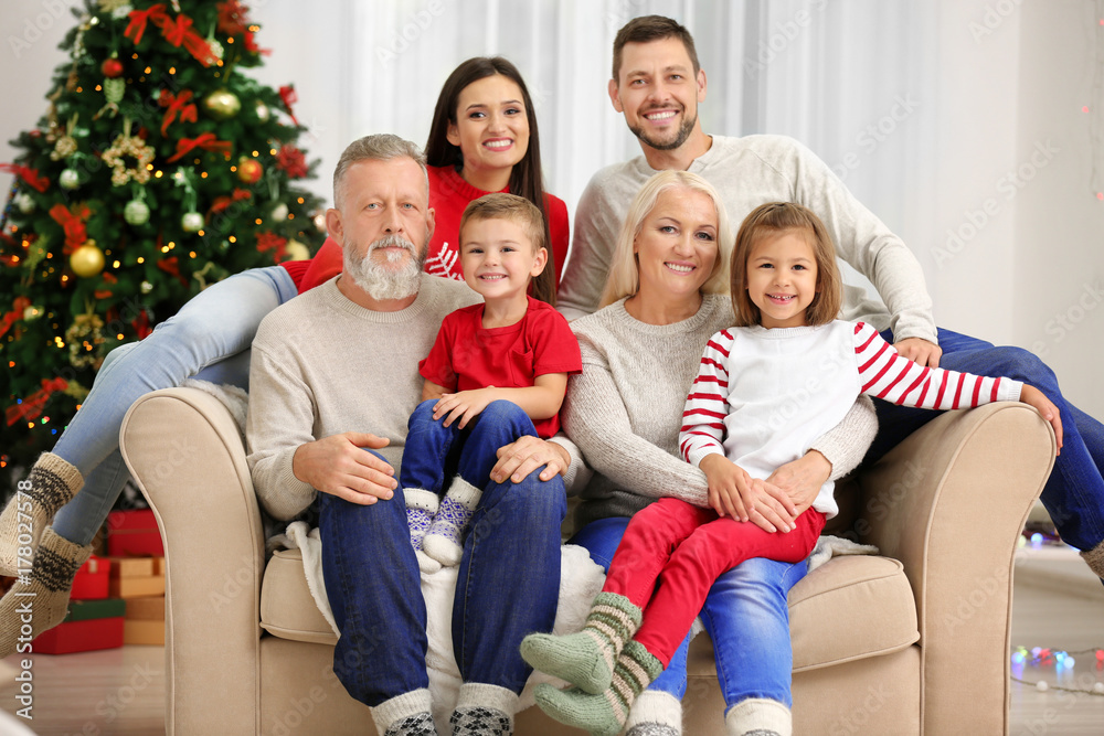 Happy family resting in room decorated for Christmas Happy family resting in room decorated for Christmas