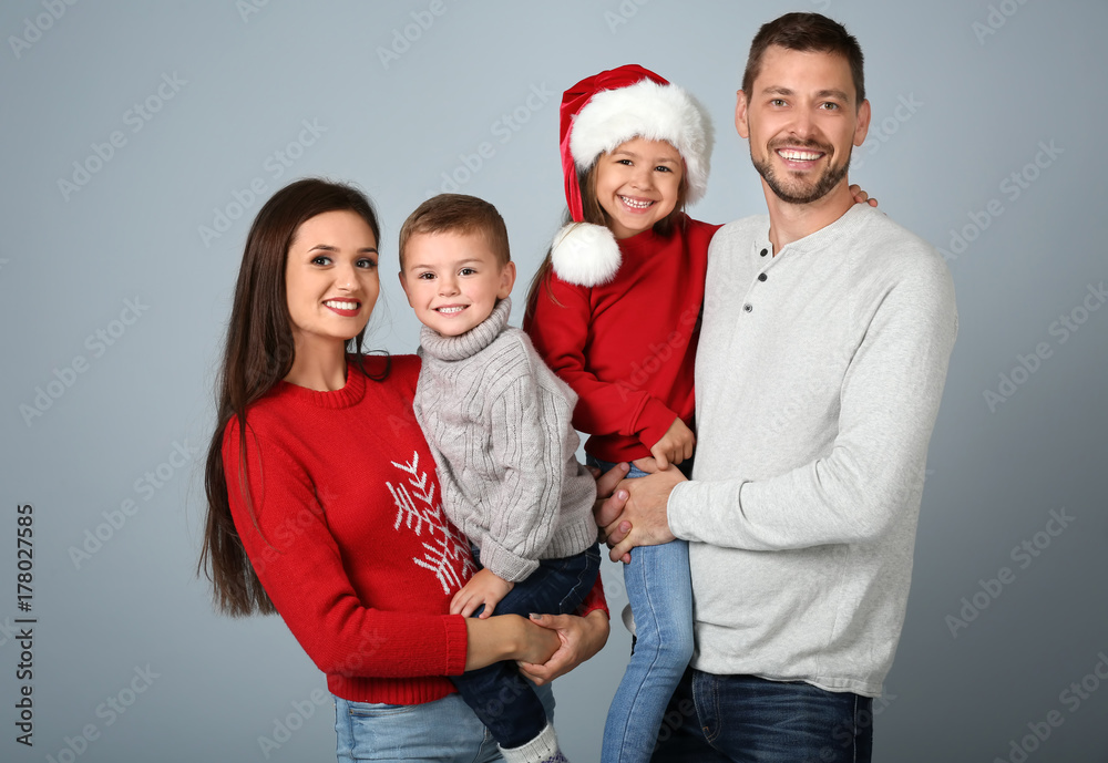 Happy family in Christmas mood on light background Happy family in Christmas mood on light background