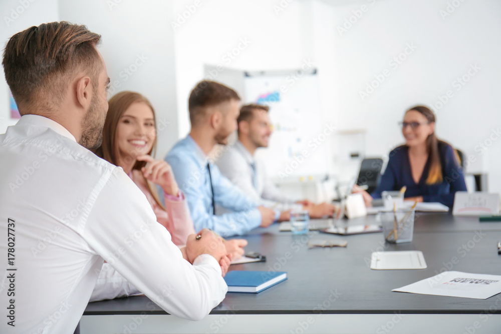 Team of young managers discussing project in office