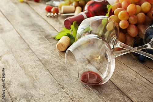 Wineglasses and grapes on wooden background